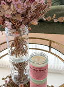 A glass jar candle with a pink label reading 'The Highland Folk. Rocky Road.